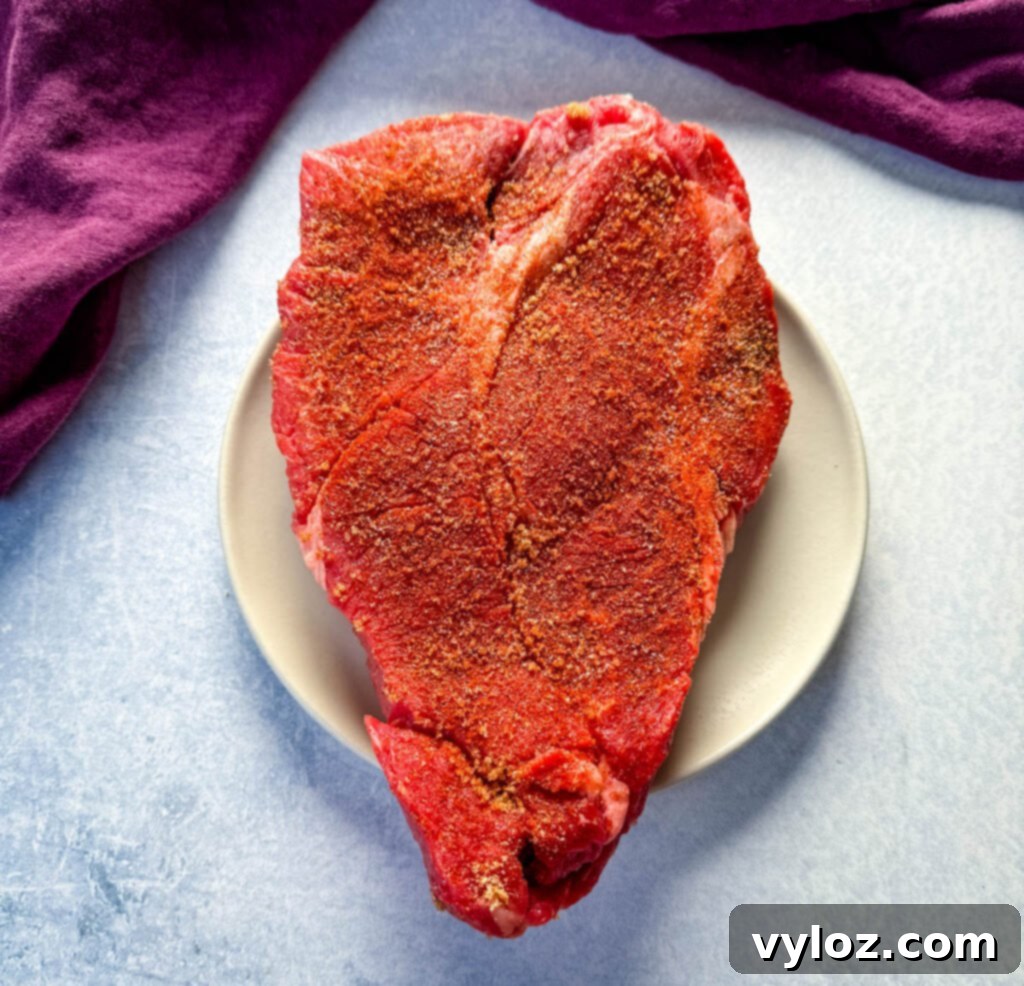 Melt-in-Your-Mouth Slow Cooker Beef Roast 5 raw seasoned pot roast on a plate