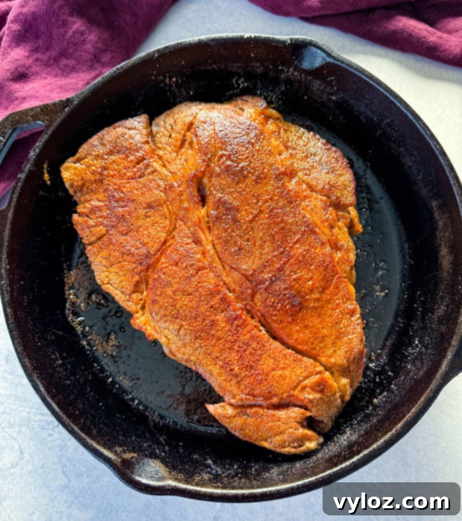 Melt-in-Your-Mouth Slow Cooker Beef Roast 6 seared pot roast in a cast iron skillet