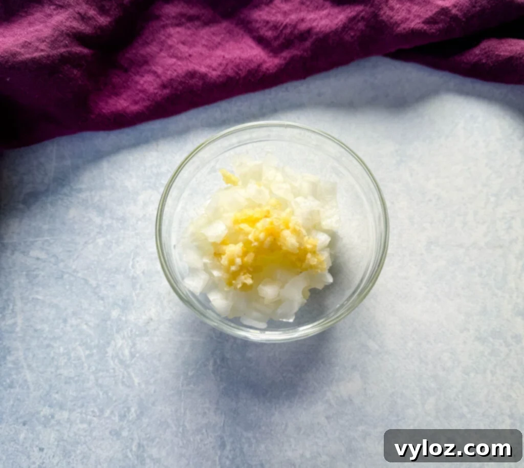 Melt-in-Your-Mouth Slow Cooker Beef Roast 7 chopped onions and garlic in a glass bowl