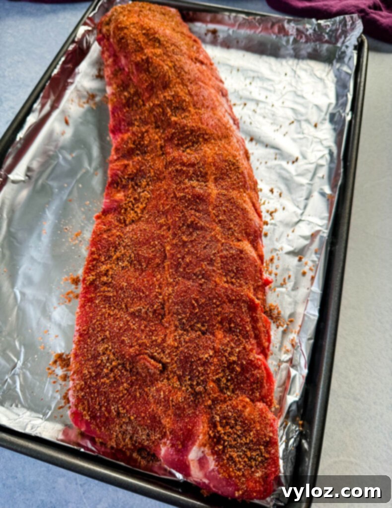 Fall-Off-The-Bone Oven Baby Back Ribs 5 raw, seasoned rack of ribs on foil