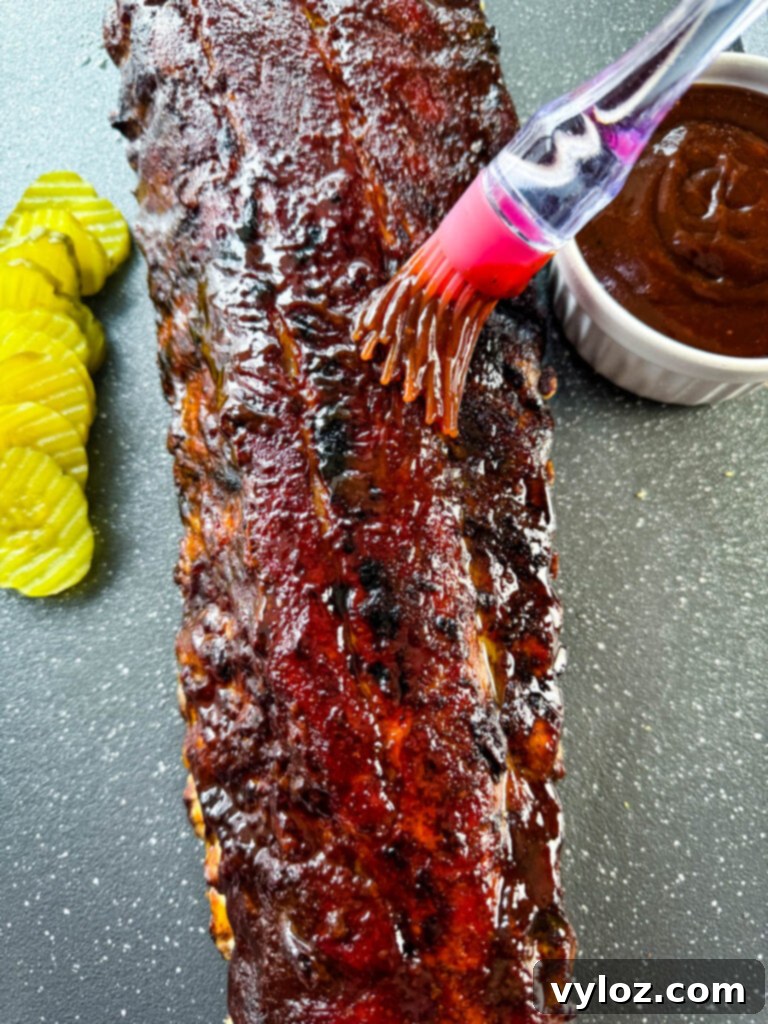 Fall-Off-The-Bone Oven Baby Back Ribs 9 oven baked ribs brushed with BBQ sauce