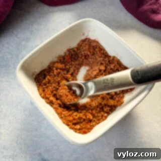 spices for rib dry rub in a white bowl with a spoon