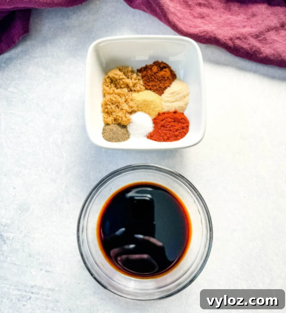 Smoky Traeger Pulled Chicken 4 BBQ dry rub spices in a white bowl and soy sauce in a glass bowl