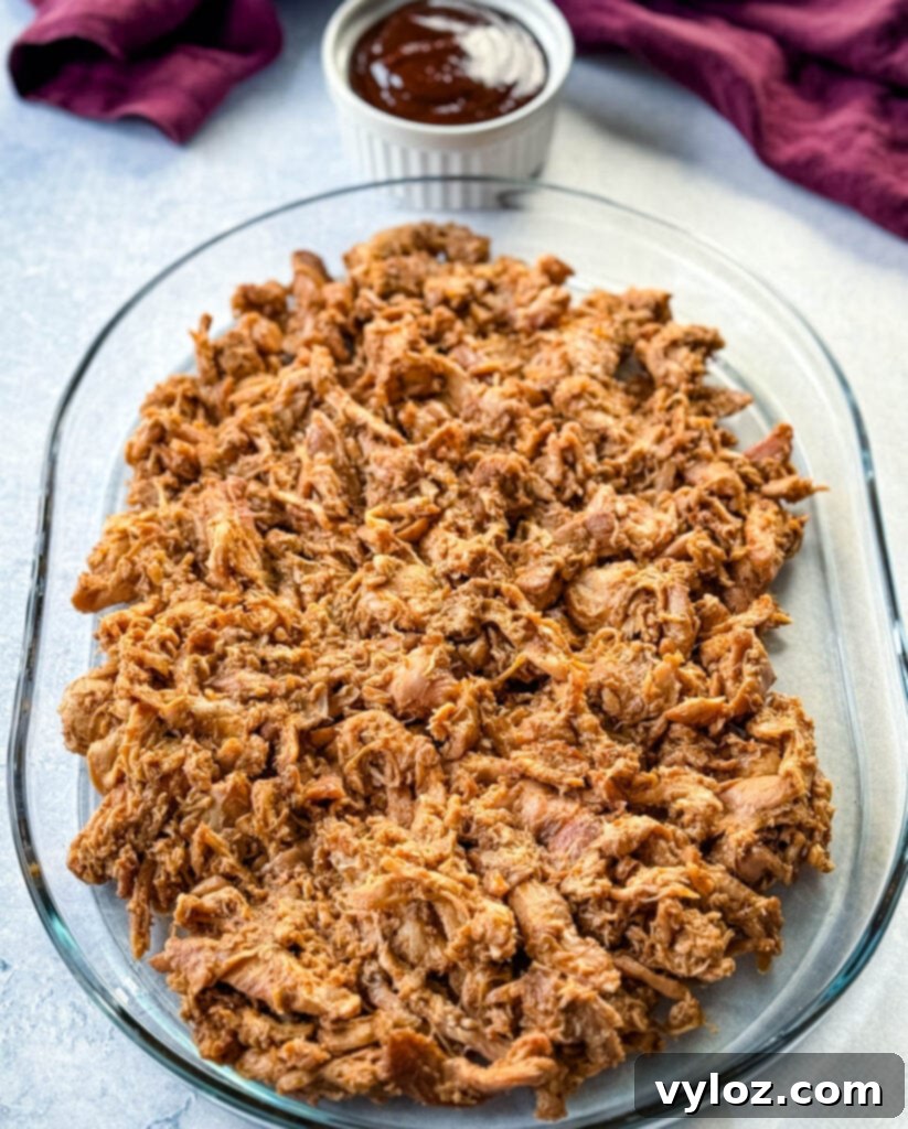 Smoky Traeger Pulled Chicken 10 smoked pulled chicken on a clear serving tray