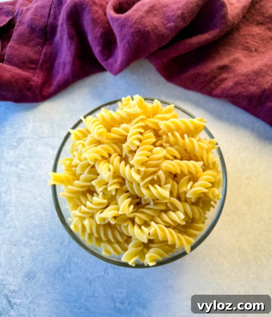 cooked rotini pasta in a glass bowl