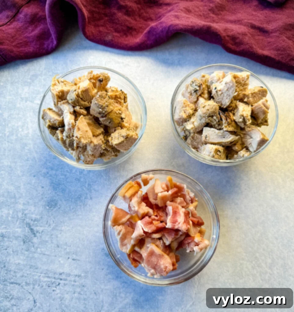 cooked chicken and bacon in separate glass bowls