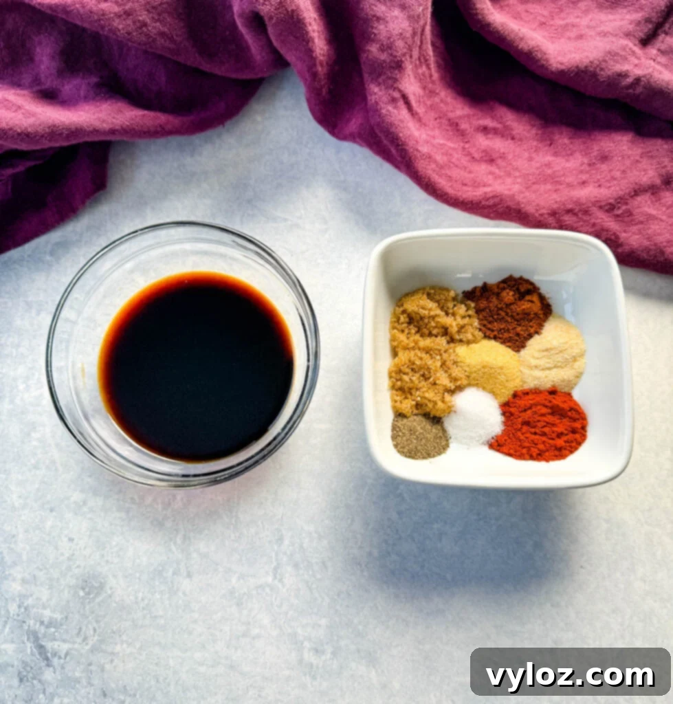 Savory Grilled Chicken Rub 4 A bowl of soy sauce and a separate bowl containing homemade chicken seasoning spices, ready to be combined.