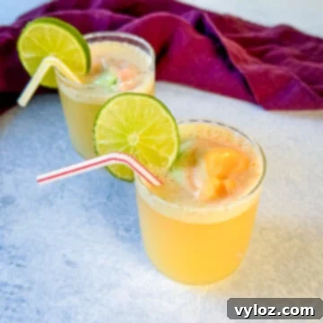 Kaleidoscope Sherbet Punch 8 rainbow sherbet punch in a cup with a lime and straw