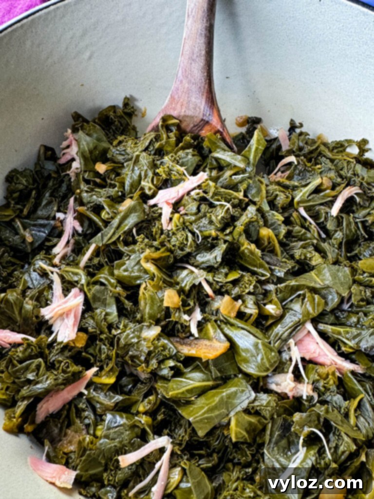 Southern Mixed Greens Medley 2 Mixed collard, turnip, mustard greens, and kale simmering in a Dutch oven with a wooden spoon