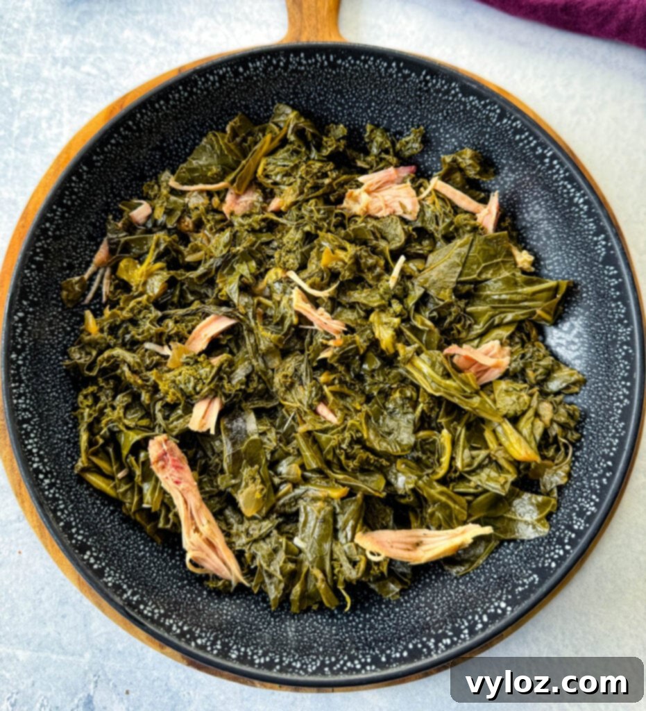 Southern Mixed Greens Medley 12 A serving of mixed greens, including collard, turnip, mustard greens, and kale, presented in a black bowl.