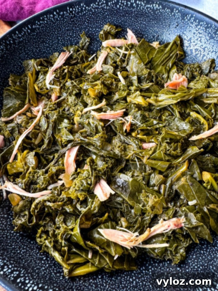Southern Mixed Greens Medley 13 Mixed collard, turnip, mustard greens, and kale in a Dutch oven with smoked turkey, presented as a finished dish.