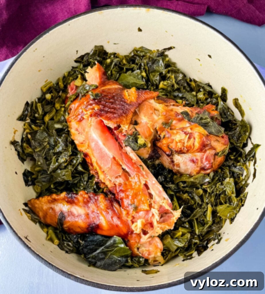 collard greens and smoked turkey simmering in a large pot, indicating a rich and flavorful dish in progress