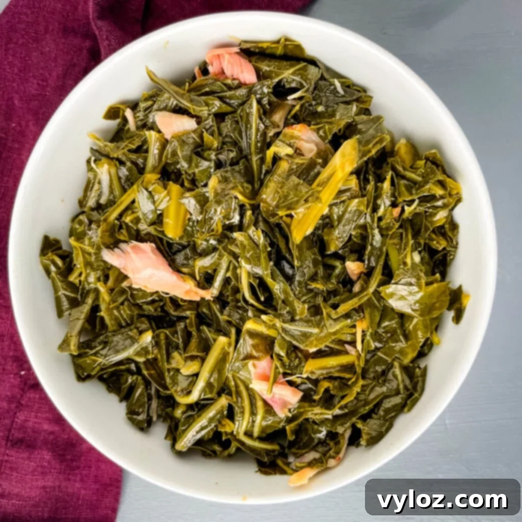southern collard greens served in a pristine white bowl, garnished beautifully and ready to be enjoyed