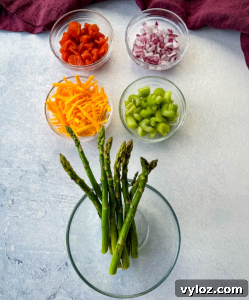 Classic Ham Pasta Salad 5 chopped tomatoes, onions, grated cheese, diced celery, and asparagus in separate glass bowls
