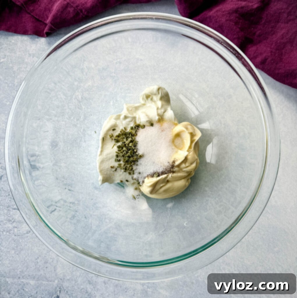 Classic Ham Pasta Salad 7 mayo, garlic powder, onion powder, and chives in a glass bowl