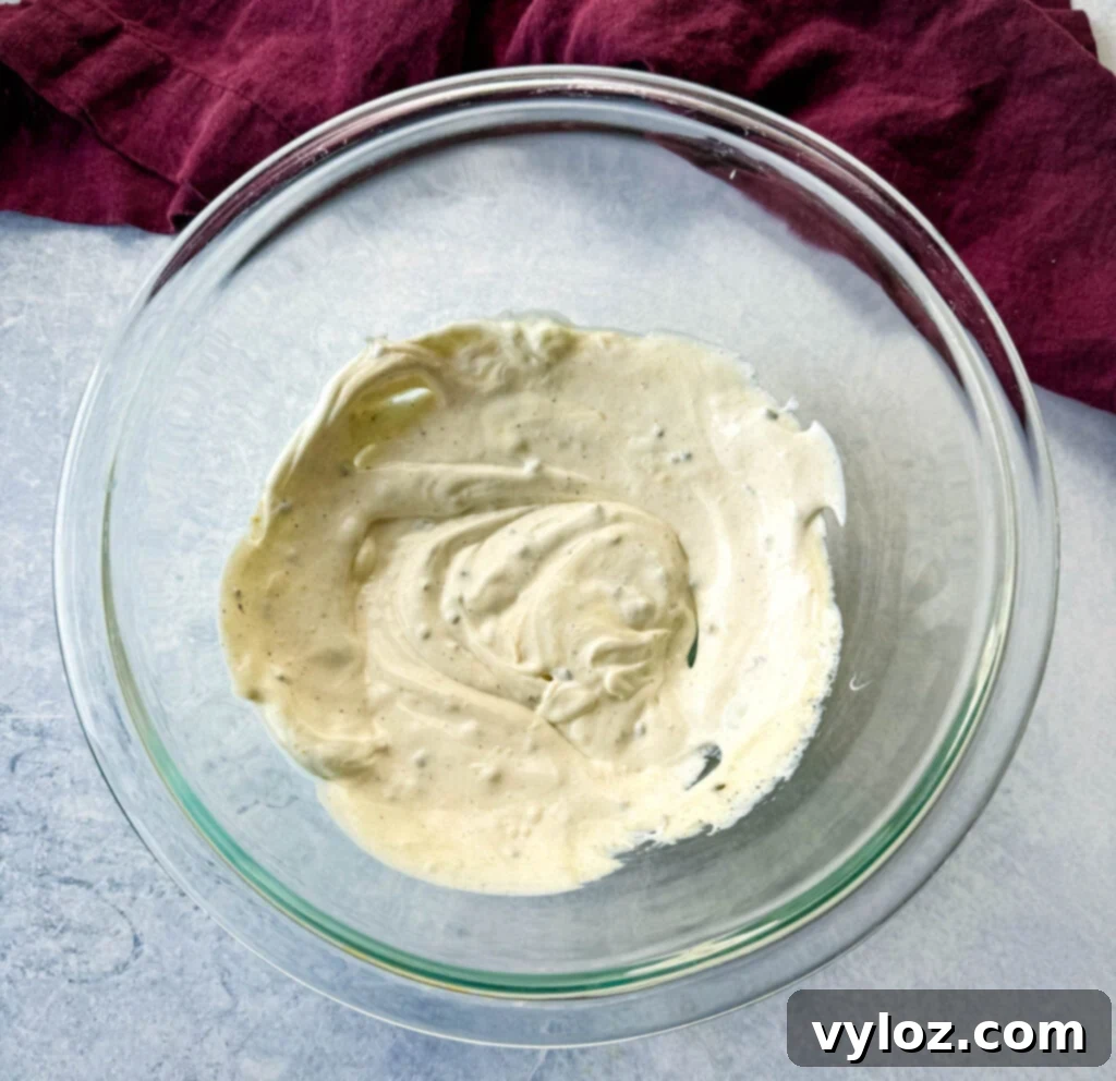 Classic Ham Pasta Salad 8 mayo, garlic powder, onion powder, and chives in a glass bowl