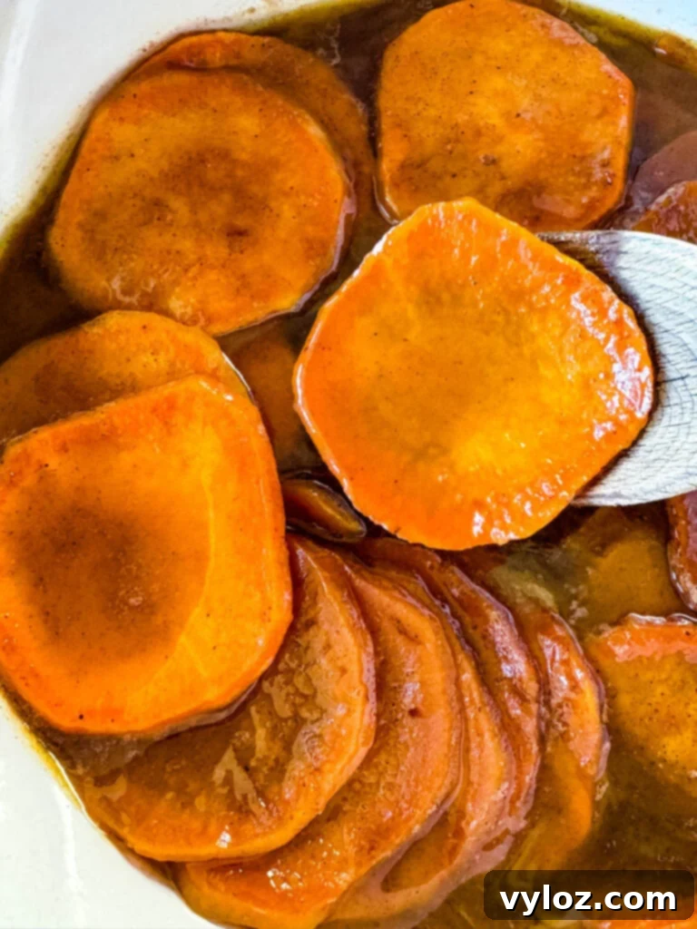 Stovetop Glazed Sweet Potatoes 10 stovetop Southern soul food candied sweet potatoes yams in a Dutch oven with a wooden spoon