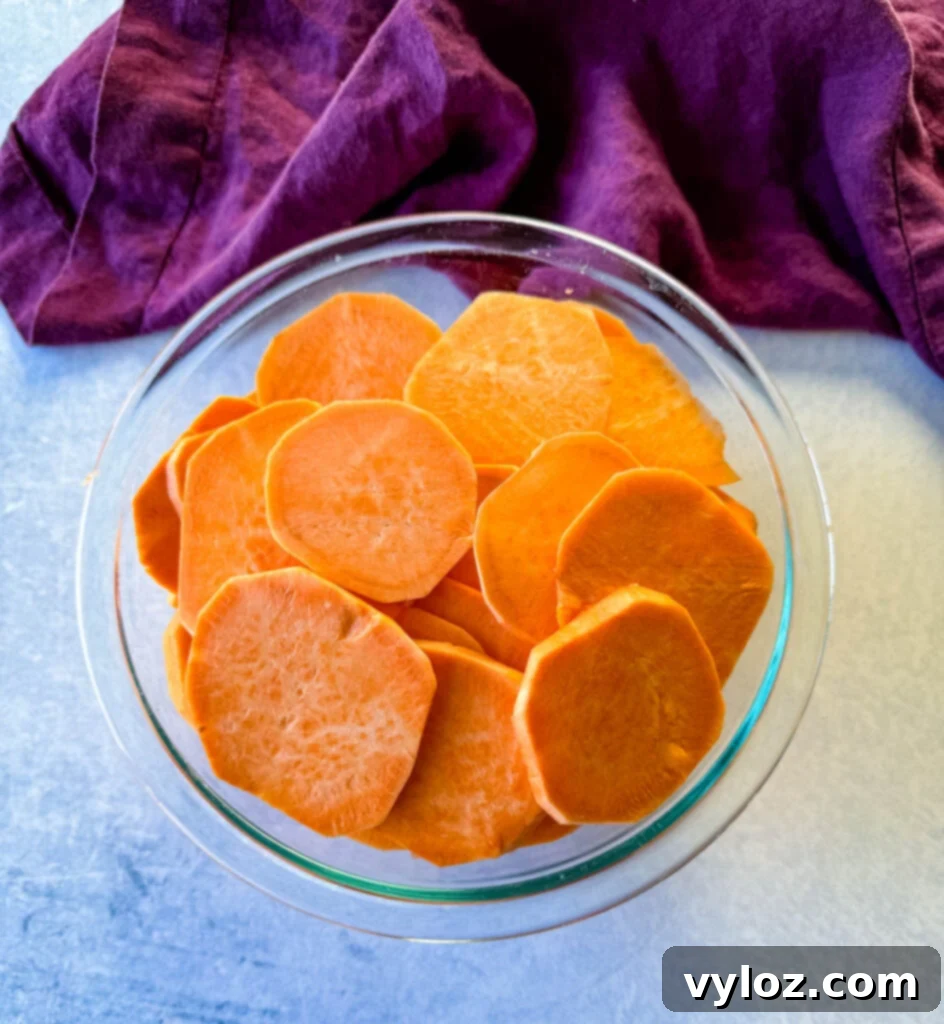 Stovetop Glazed Sweet Potatoes 5 sweet potatoes sliced into rounds in a glass bowl