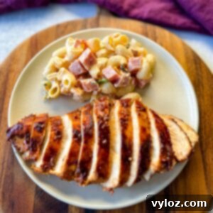 baked bbq chicken on a plate with pasta salad