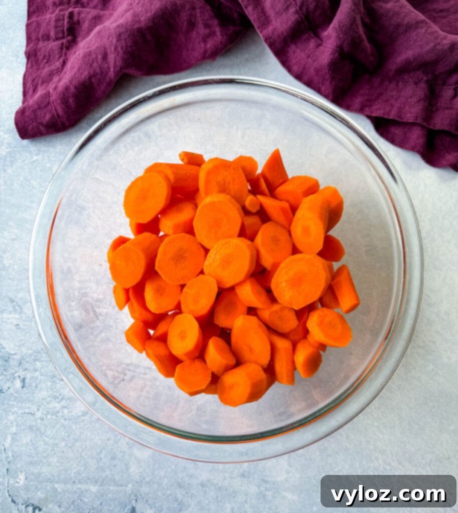 Sweet Glazed Carrots 5 Neatly diced carrots in a glass bowl, showcasing their even size for consistent cooking.