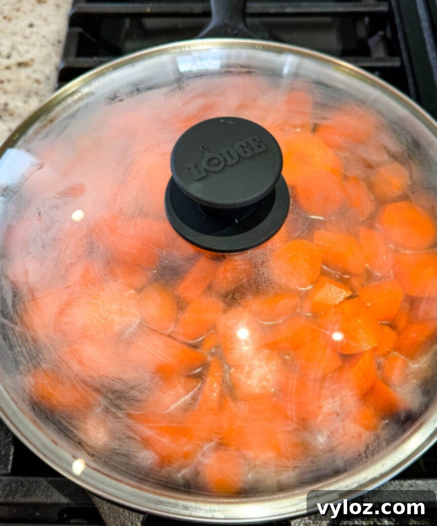 Sweet Glazed Carrots 9 A close-up view of richly coated candied carrots in a cast iron skillet, ready to be served.
