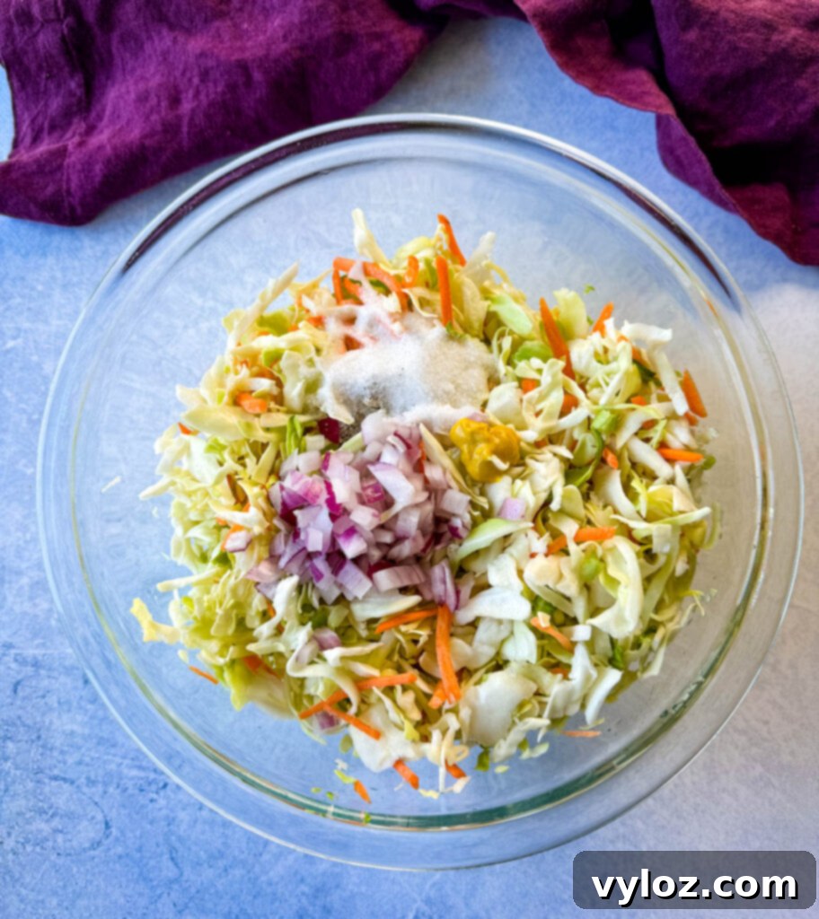 A close-up shot of vinegar coleslaw in a stylish glass bowl, ready to be served