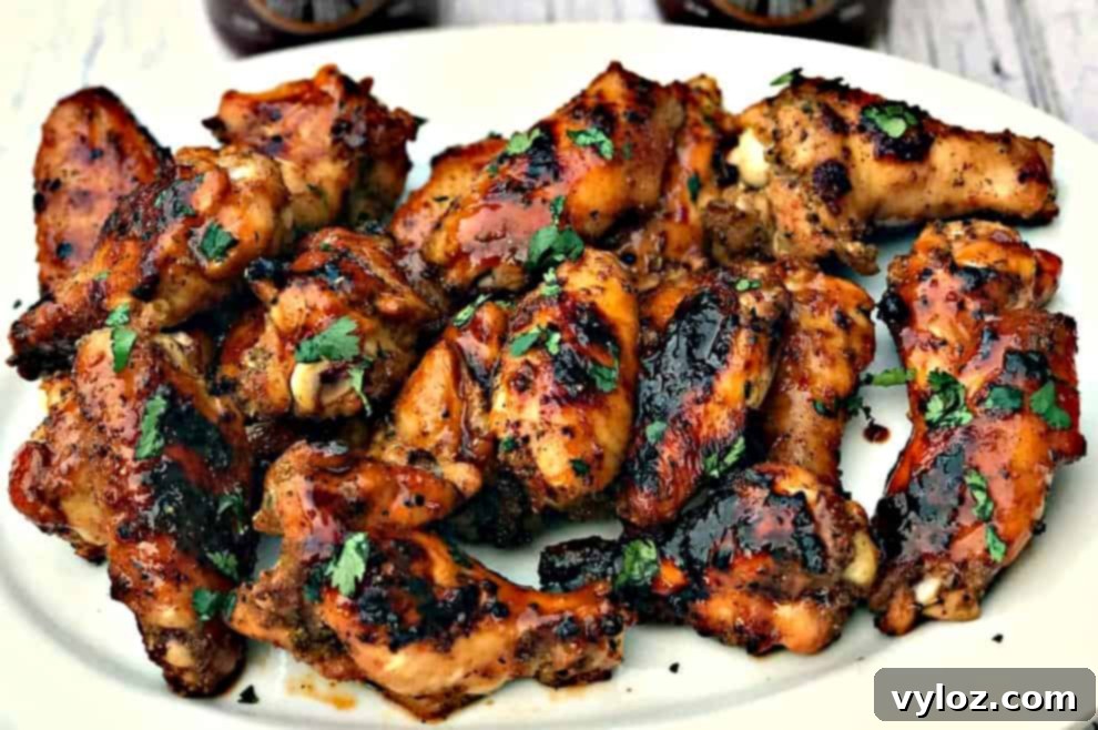 Charred BBQ Ranch Chicken Wings 2 Platter of BBQ Ranch Grilled Chicken Wings, garnished with fresh parsley.