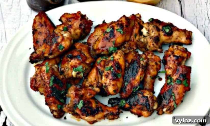 Charred BBQ Ranch Chicken Wings 4 Another view of BBQ Ranch Grilled Chicken Wings on a white plate, showcasing their inviting appearance.