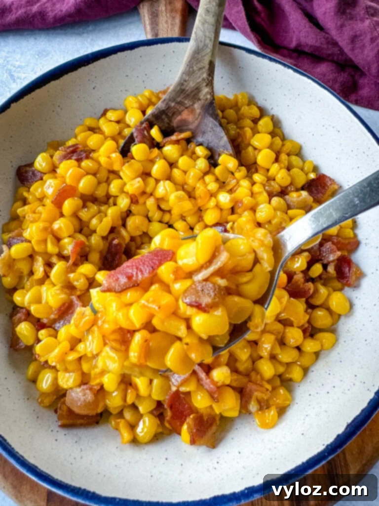 Golden Crispy Fried Corn 11 Southern fried corn with butter and bacon in a white bowl with a spoon