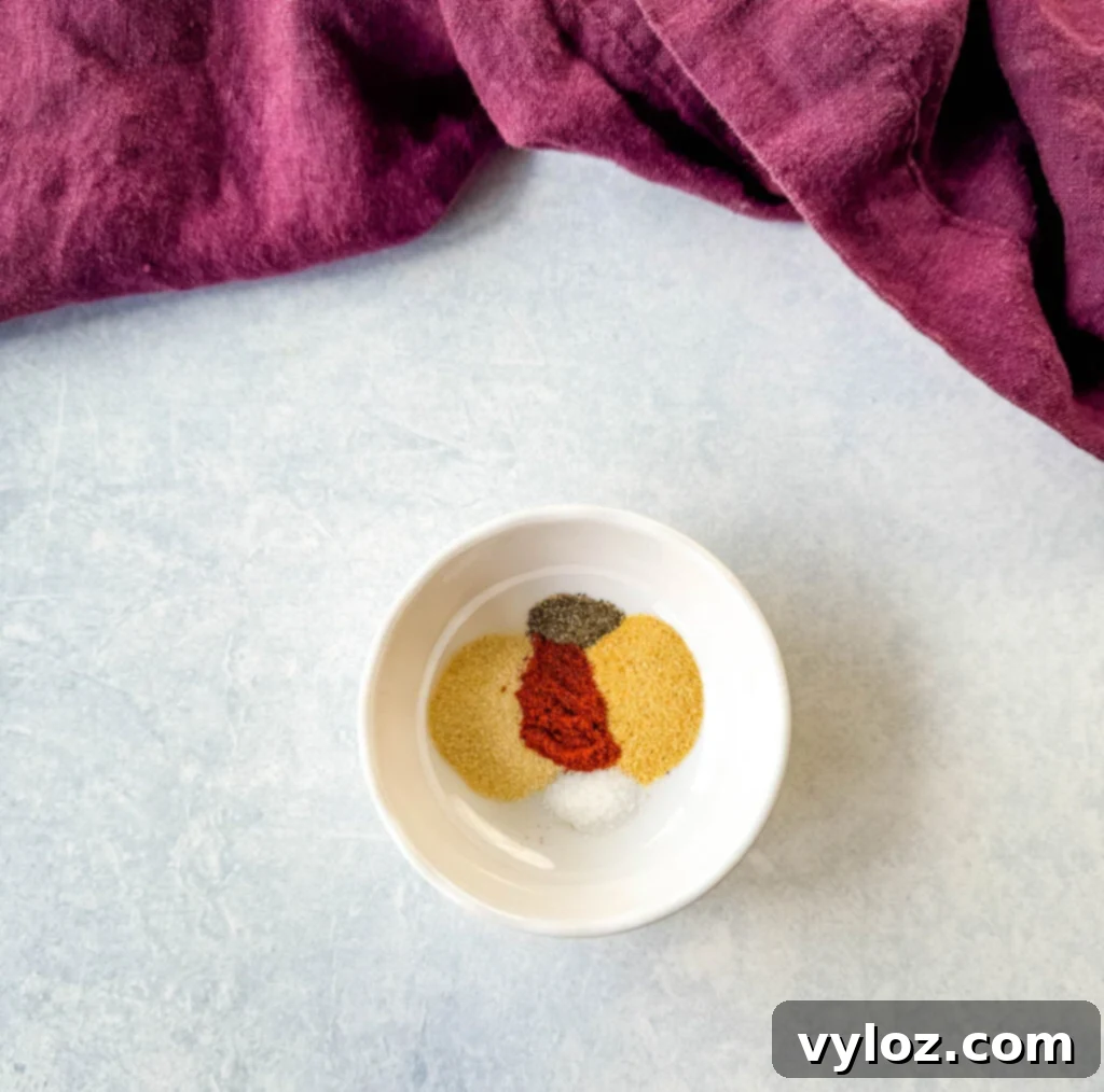 Golden Crispy Fried Corn 5 smoked paprika, onion powder, garlic powder, salt, and pepper in a white bowl