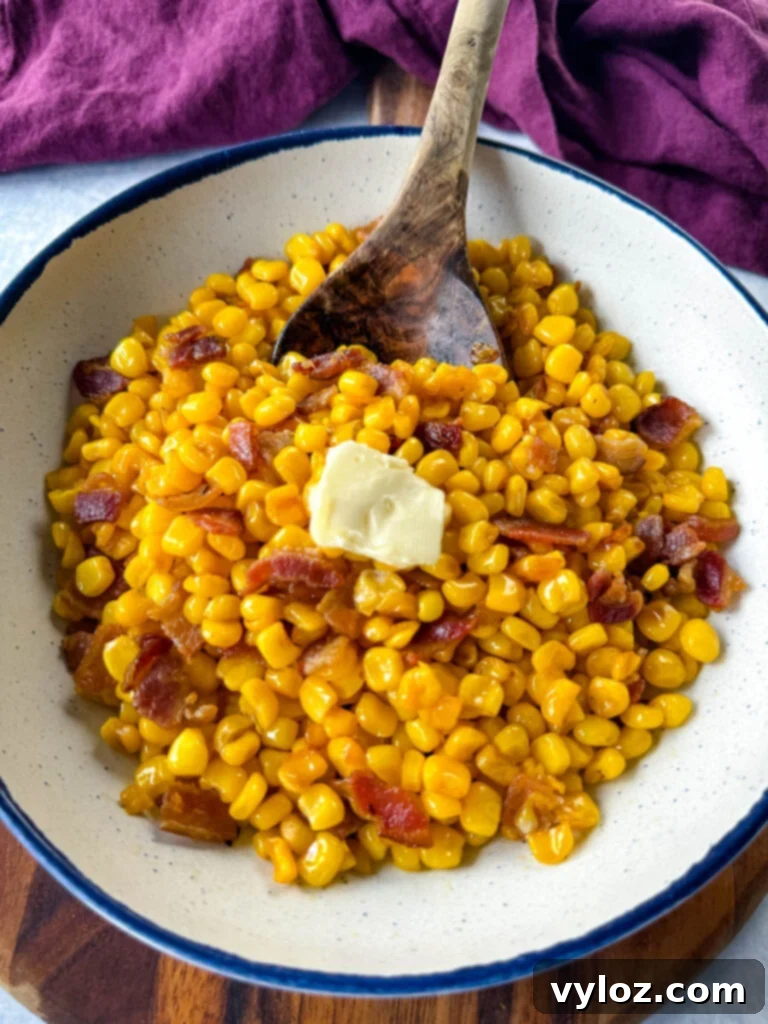 Golden Crispy Fried Corn 10 Southern fried corn with butter and bacon in a white bowl