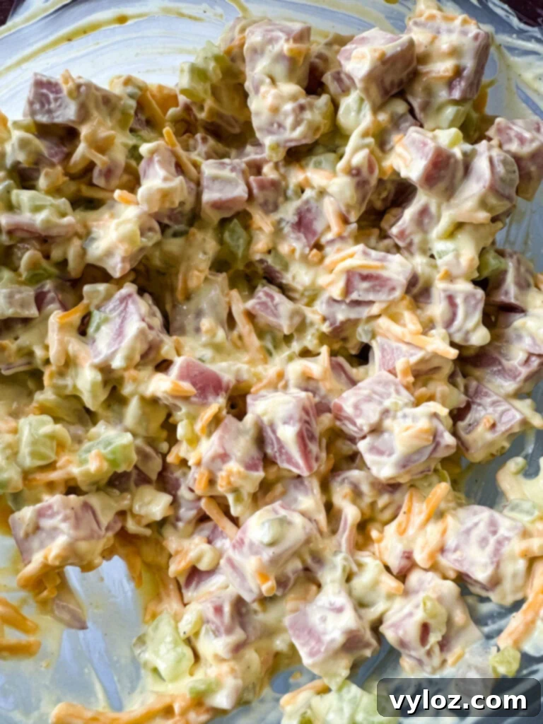 Classic Creamy Ham Salad 7 ham salad with cheese in a glass bowl