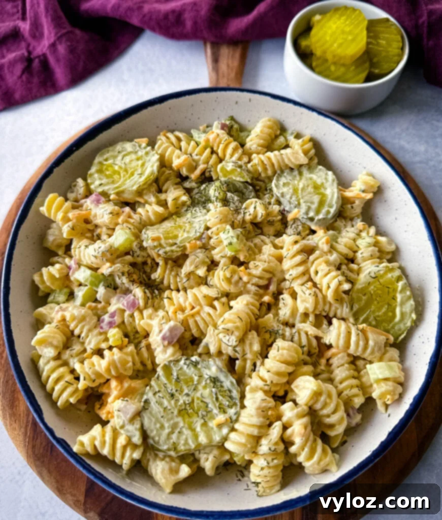 Zingy Dill Pasta Salad 12 A beautifully presented bowl of creamy dill pickle pasta salad, ready to be enjoyed, with a focus on its inviting texture and colors.