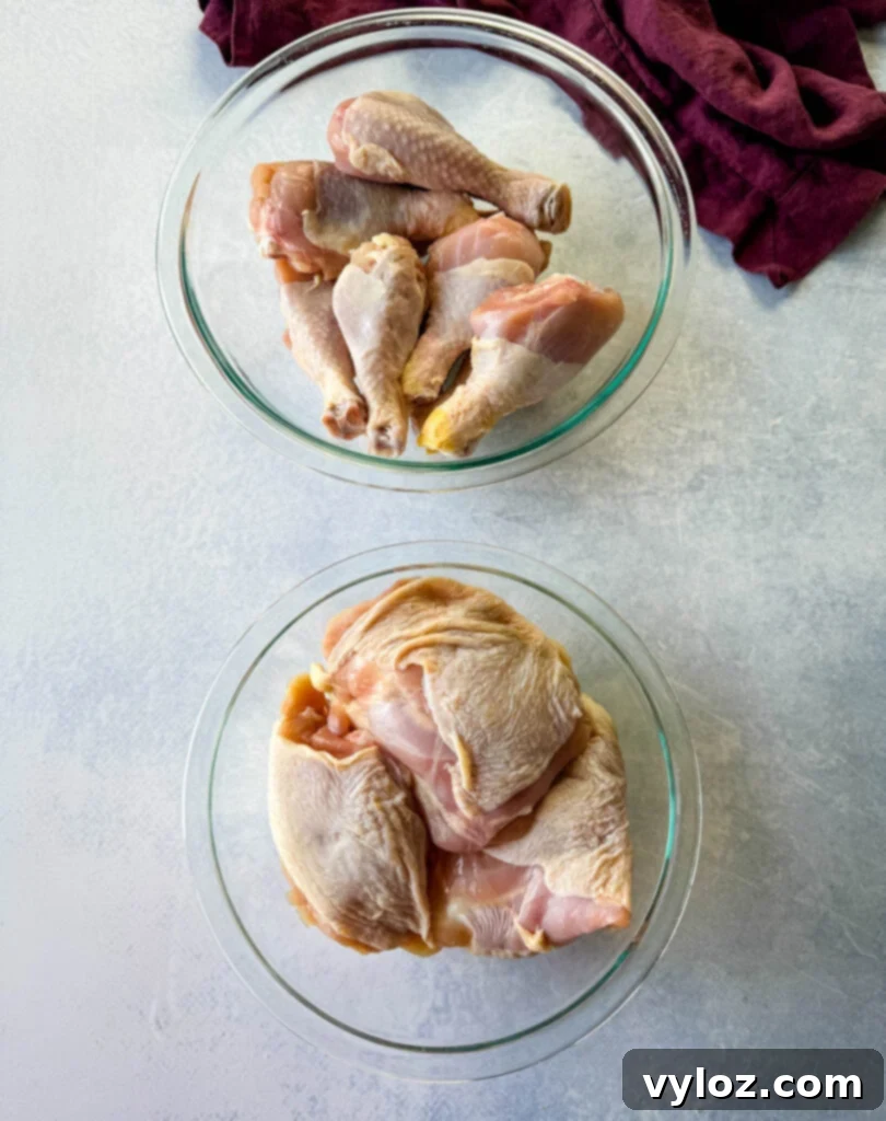 raw chicken thighs and drumsticks in glass bowls
