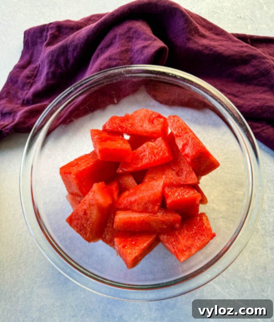 Bowl of fresh, vibrant watermelon cubes, ready for blending into refreshing water.