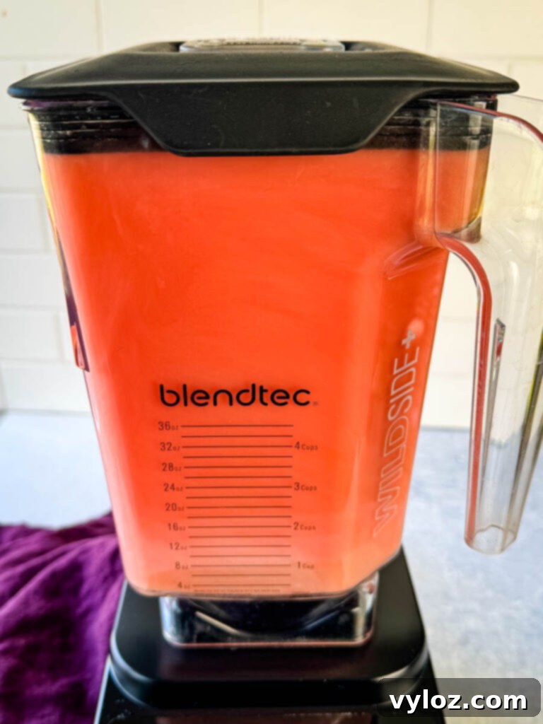 Close-up of watermelon blending in a blender, showing the process of creating watermelon water.
