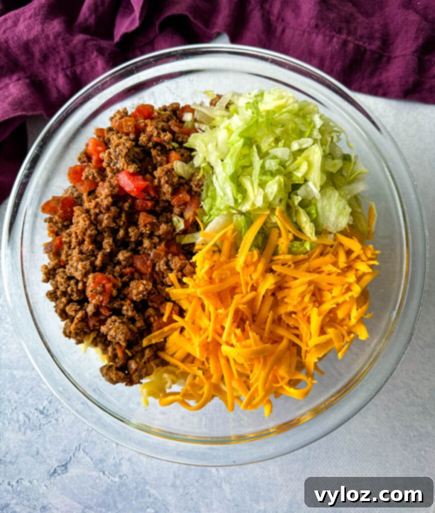 Taco pasta salad with ground beef in a glass bowl