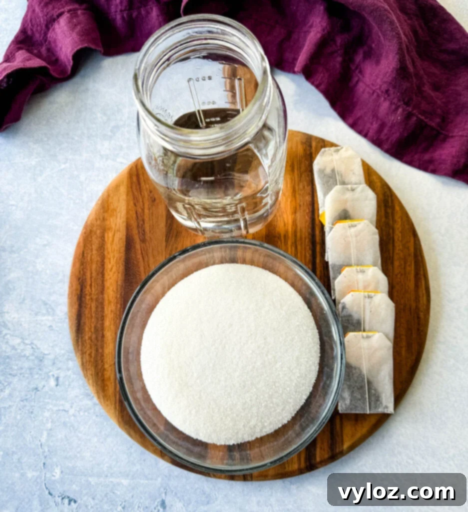 Ingredients for peach simple syrup: water, tea bags, and sugar or sweetener on a flat surface