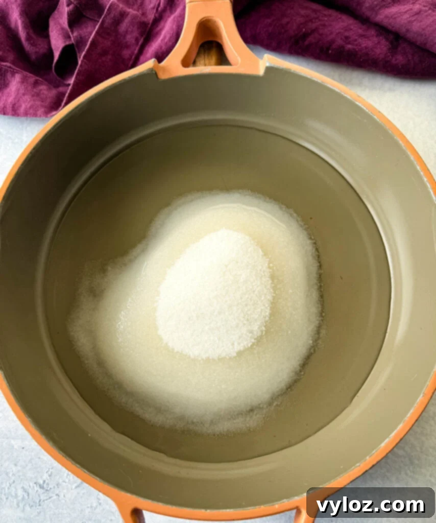 Water and sweetener heating in a skillet to create a simple syrup