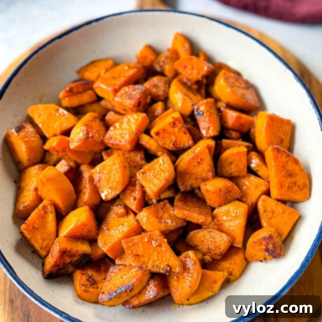 Golden-brown fried sweet potatoes served in a white bowl, ready to be enjoyed.