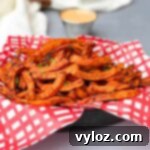 air fryer sweet potato fries served in a fry basket