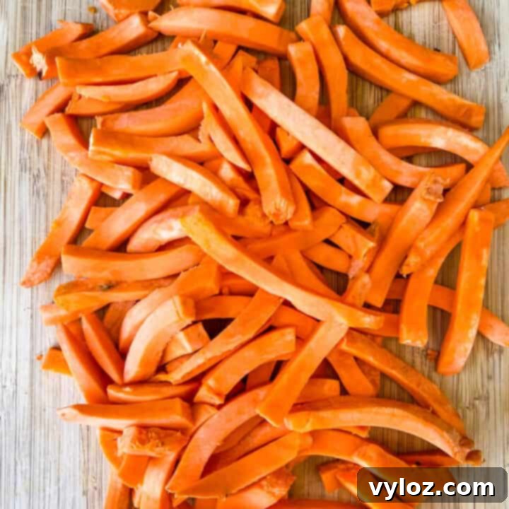 raw sweet potatoes sliced on a cutting board