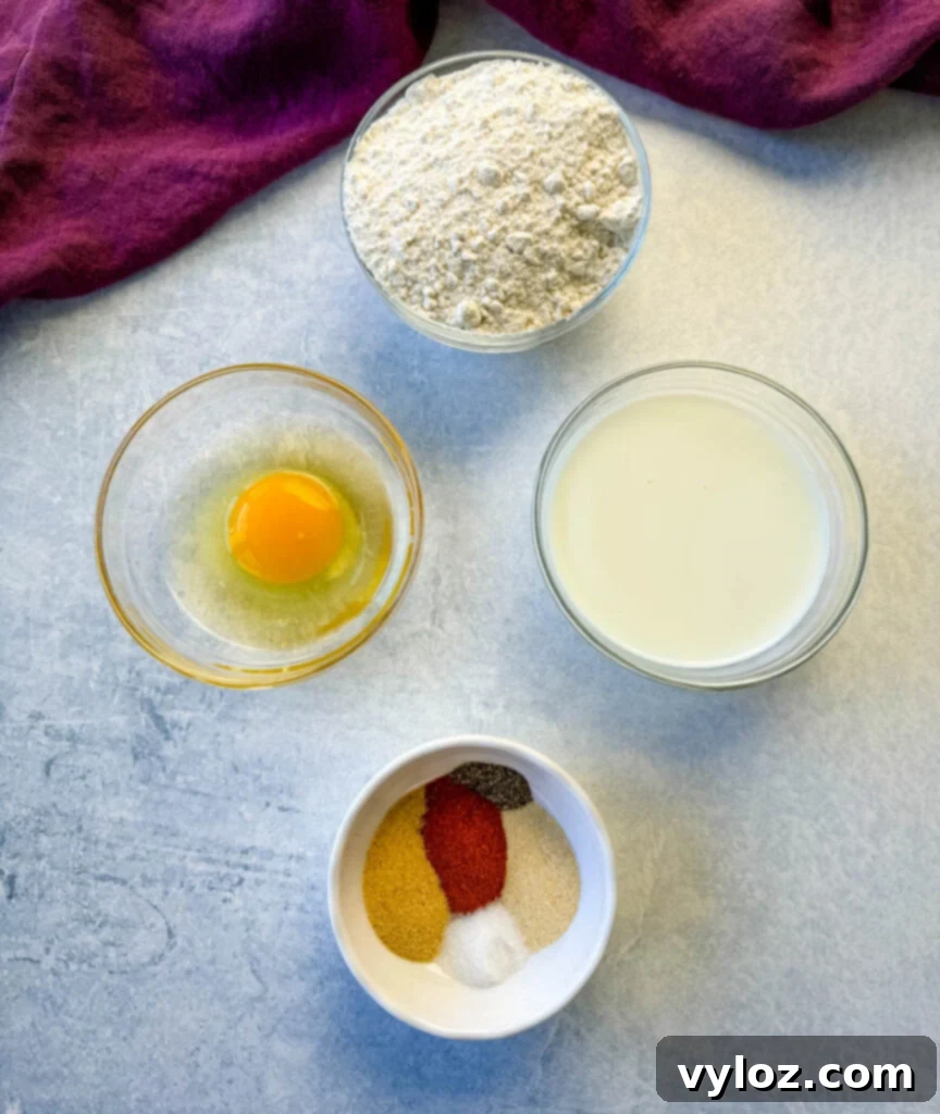 Separate bowls of seasoned flour, whisked egg, and buttermilk, essential for perfect chicken breading.