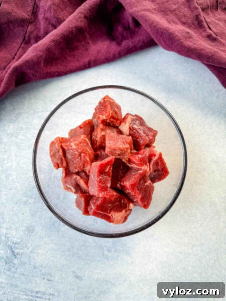 raw steak diced into pieces in a glass bowl