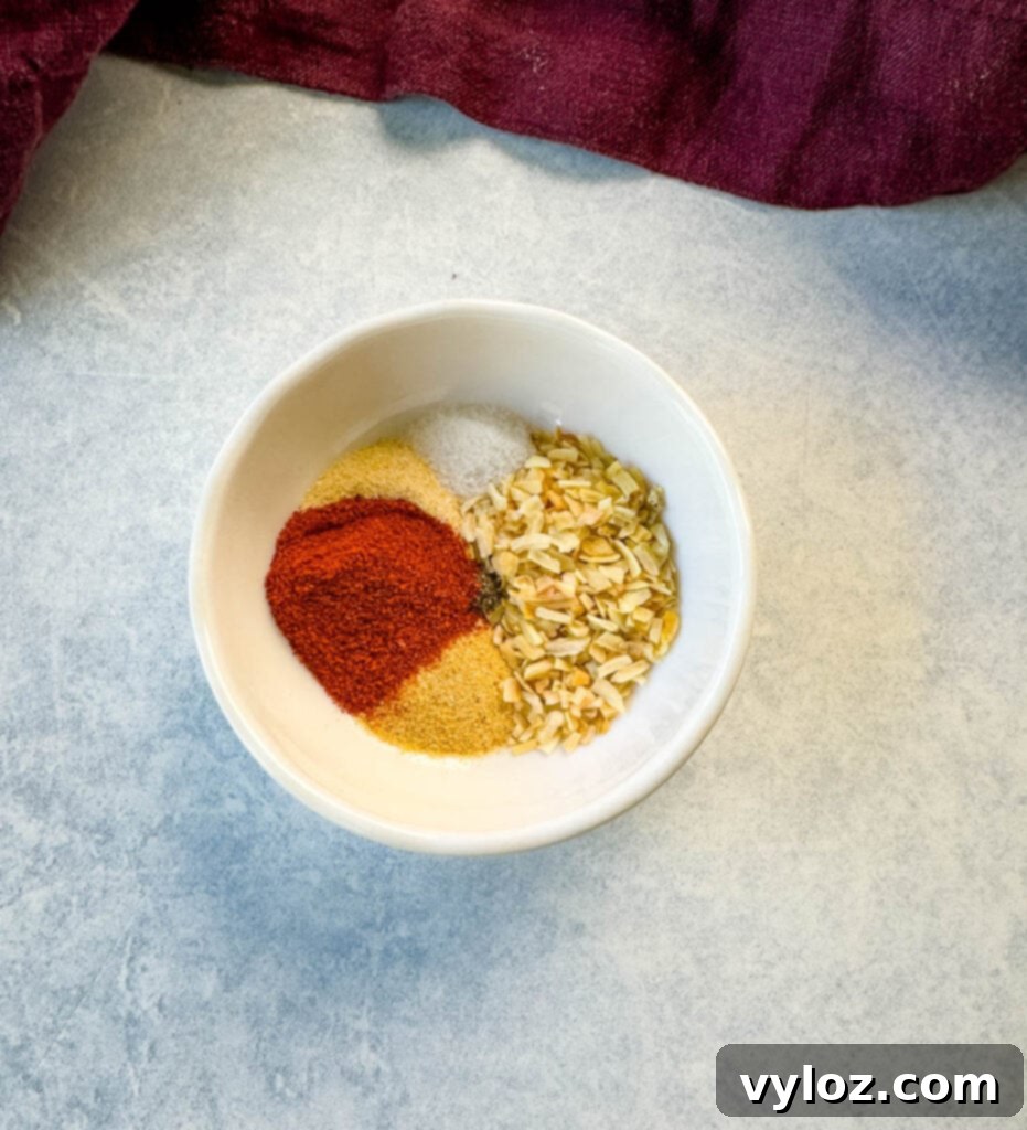 Cheesy Taco Burgers 3 homemade burger rub spices and seasoning in a white bowl