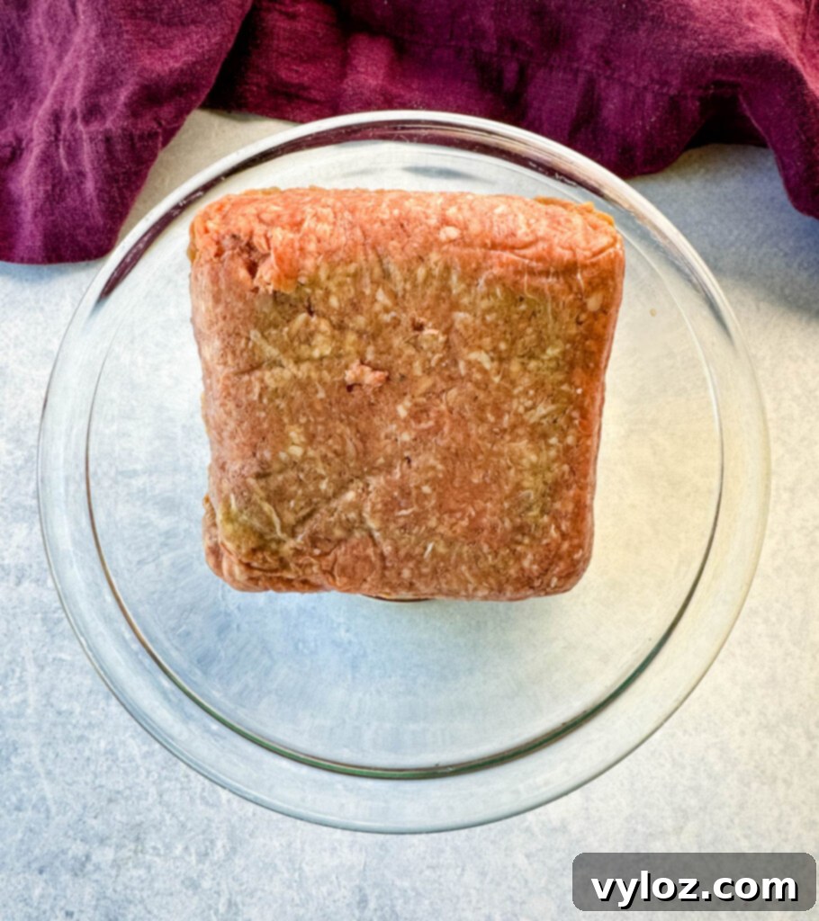 Cheesy Taco Burgers 4 raw ground beef in a glass bowl