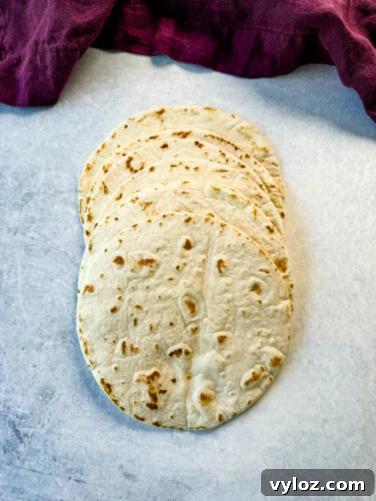 Cheesy Taco Burgers 5 flour tortillas on a flat surface