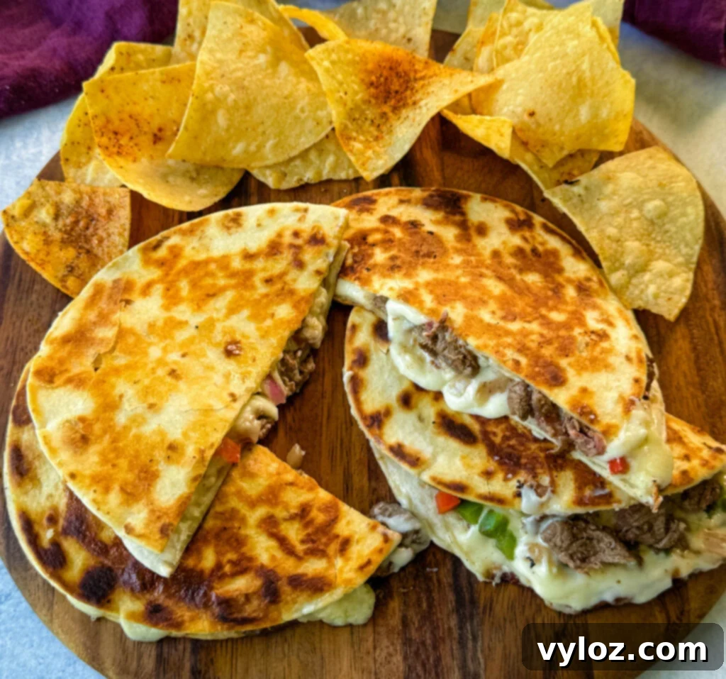 Philly cheesesteak quesadillas on a plate with chips