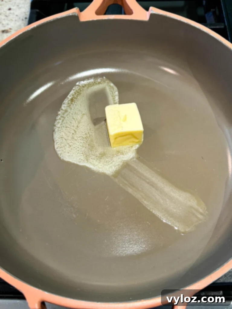 Melted butter shimmering in a non-stick skillet over medium heat