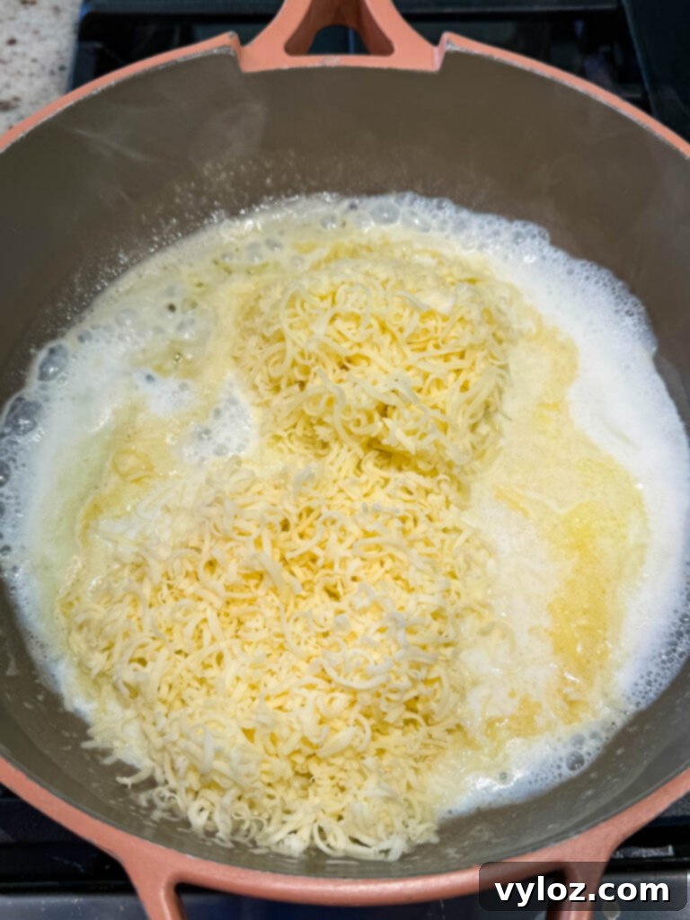 Creamy homemade Cheez Whiz cooking in a skillet, almost ready to serve